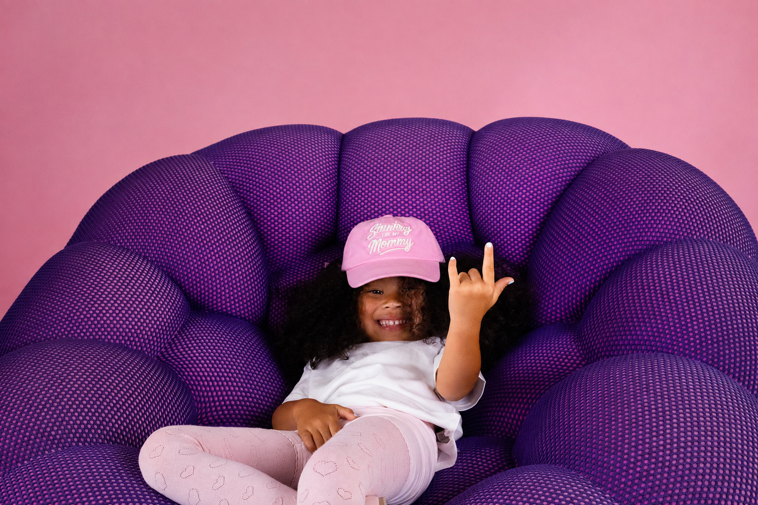 A child playing in their pink Stunting Like My Mommy hat